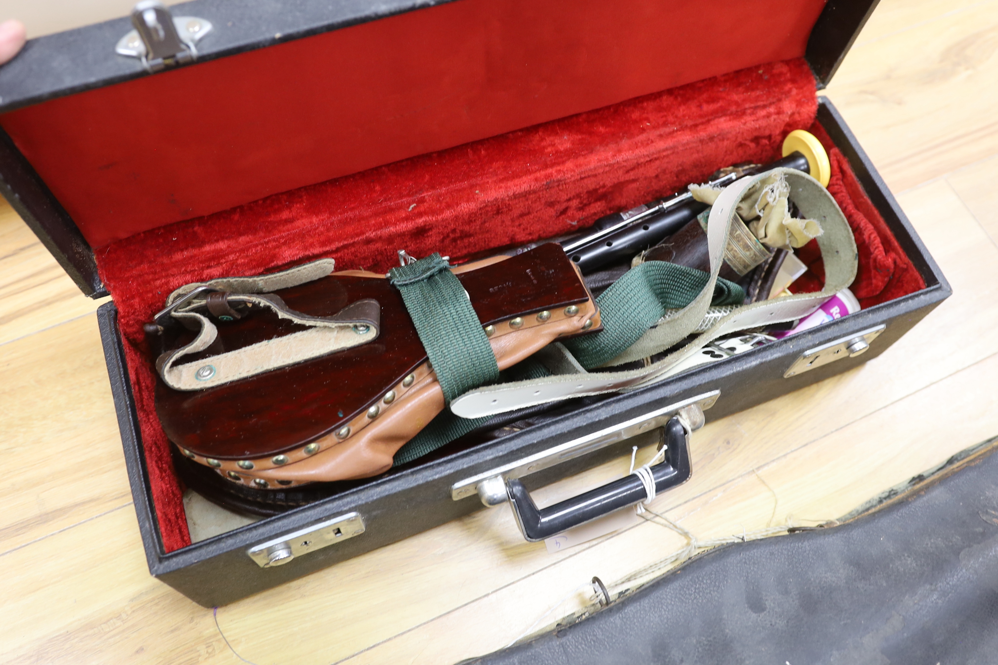 One violin, three violin cases and a cased set of bagpipes